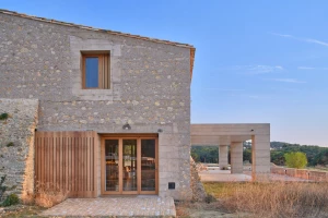 HARQUITECTES designs contemporary farm-style house around ruins of old farmhouse