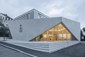 LOCALARCHITECTURE wraps Lausanne church extension in an exposed textured concrete shell